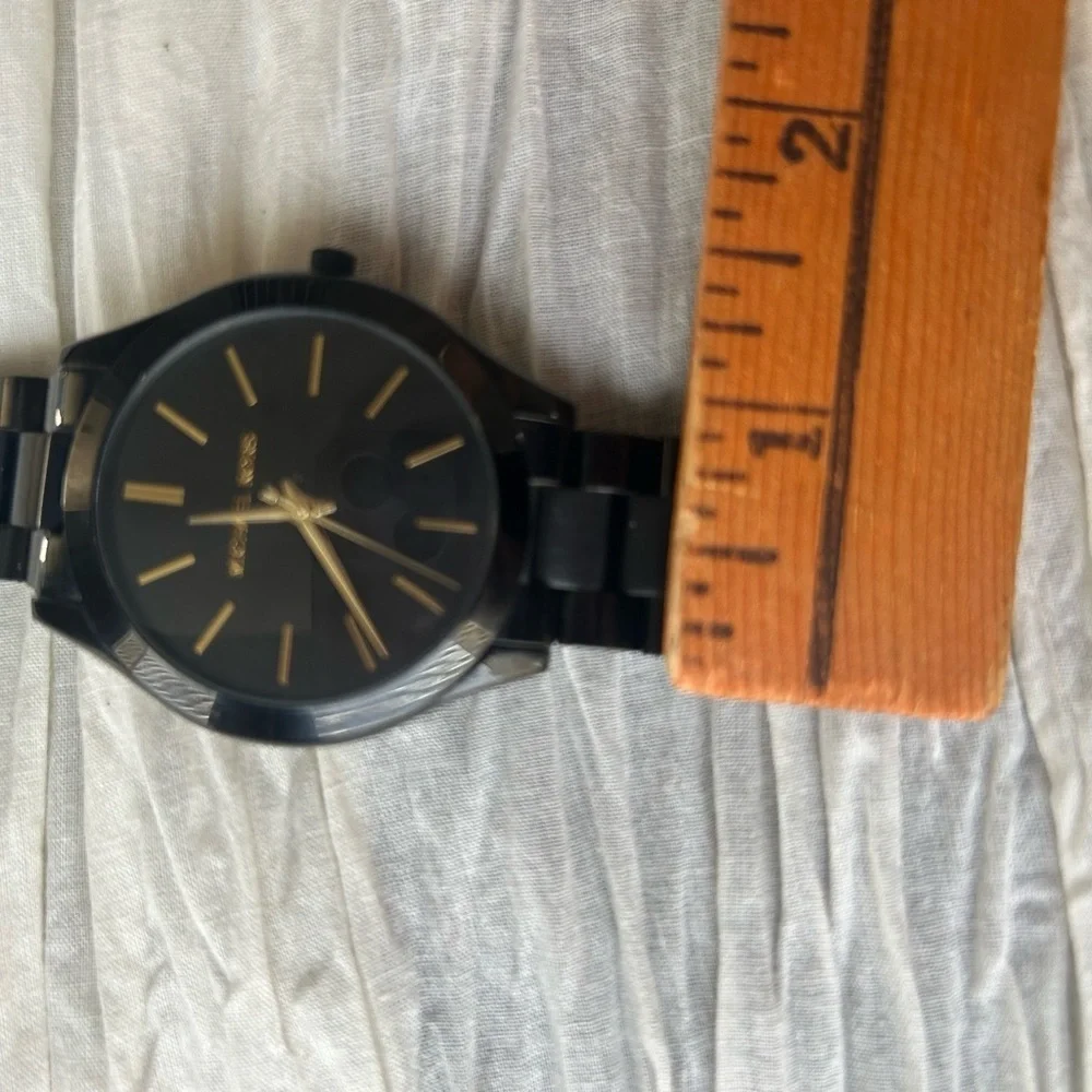 Michael Kors Black and Gold Watch It needs a battery replacement.